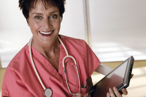 Image of smiling older female doctor with tablet