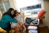 Elderly woman with caregiver using Telehomecare
